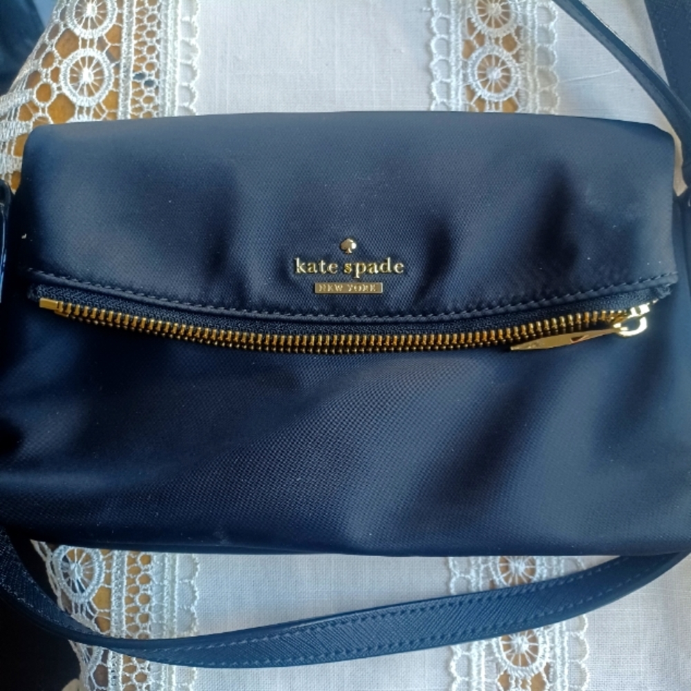 Kate Spade black canvas folding bag with magnetic clip. Excellent condition.